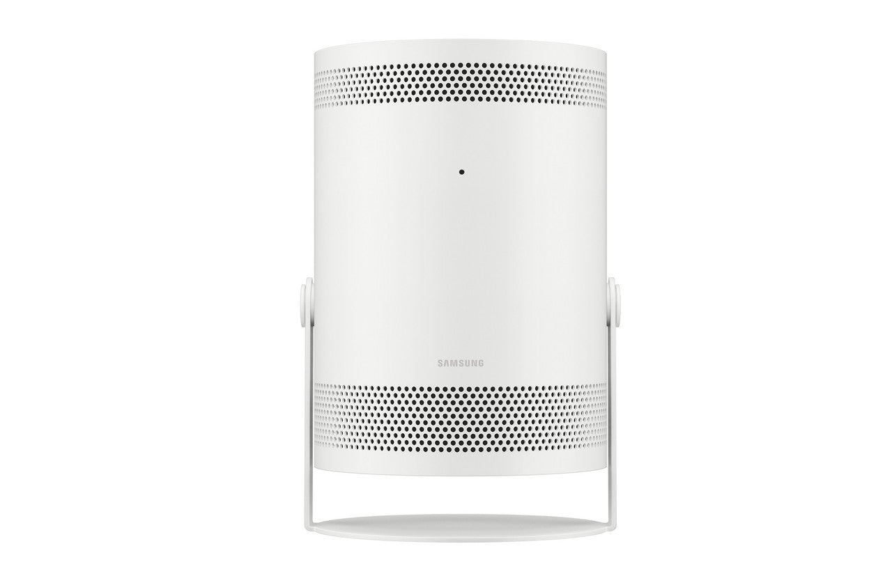 A white cylindrical Samsung smart projector with a minimalist metal stand, shown against a solid white background.