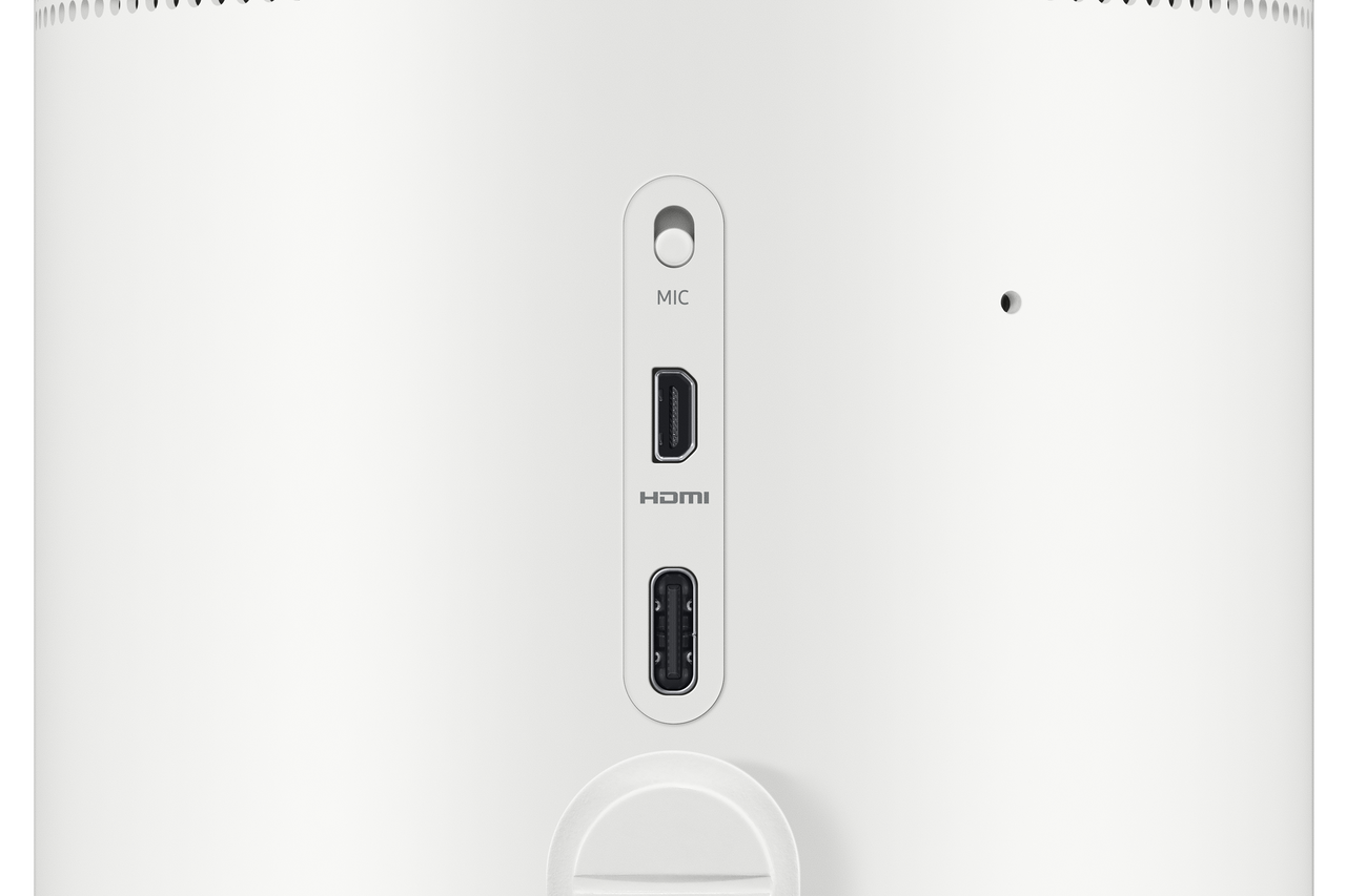 Close-up of the rear port area of a white smart projector, showing a round MIC jack, an HDMI port, and an HDMI port vertically aligned below the HDMI connector.
