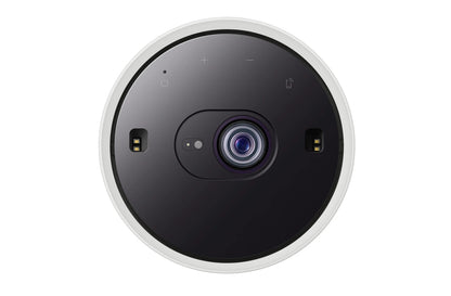 A top-down view of a circular smart home cenima projector with a black face, white outer rim, and a blue-tinted lens, shown on a solid white background.
